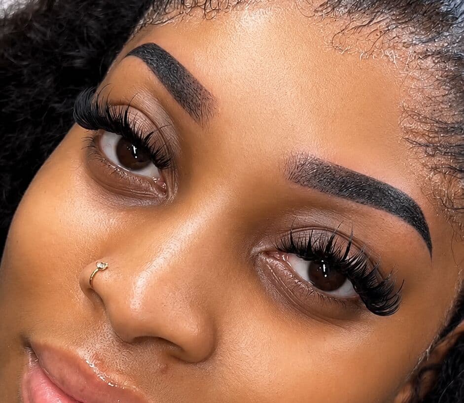 Luxury lash extensions and perfectly sculpted brows on an elegant woman